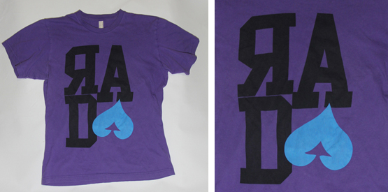 Custom screen print on a purple shirt by Spectrum Apparel Printing 